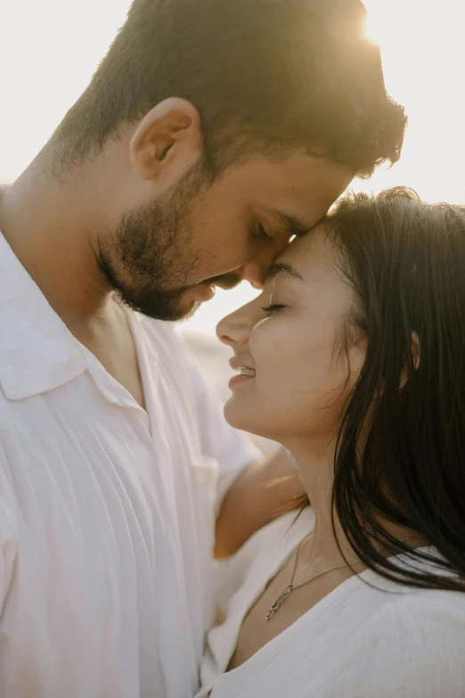 a man and a woman standing together, the woman is hugging her forehead