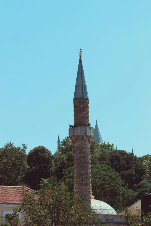 the top of a brick tower is shown with two clocks