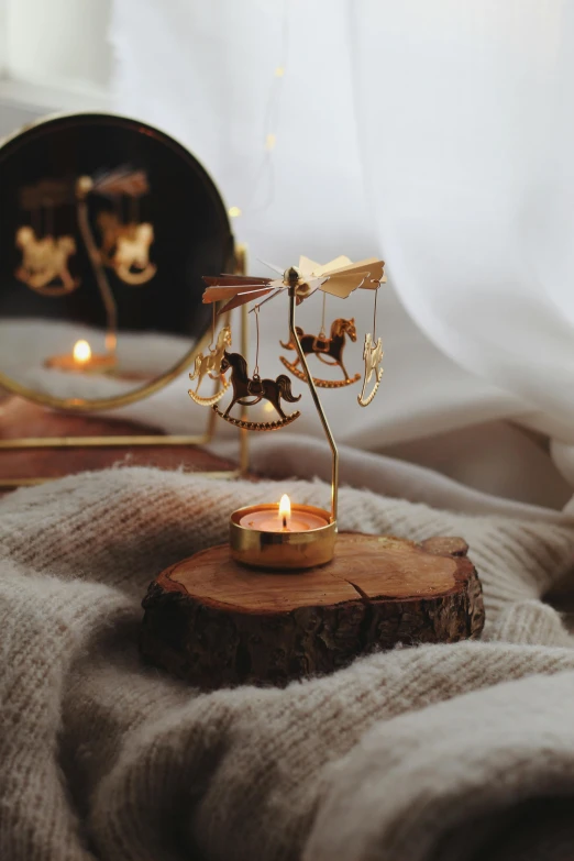 an artistic miniature gold candle holder with horses on it