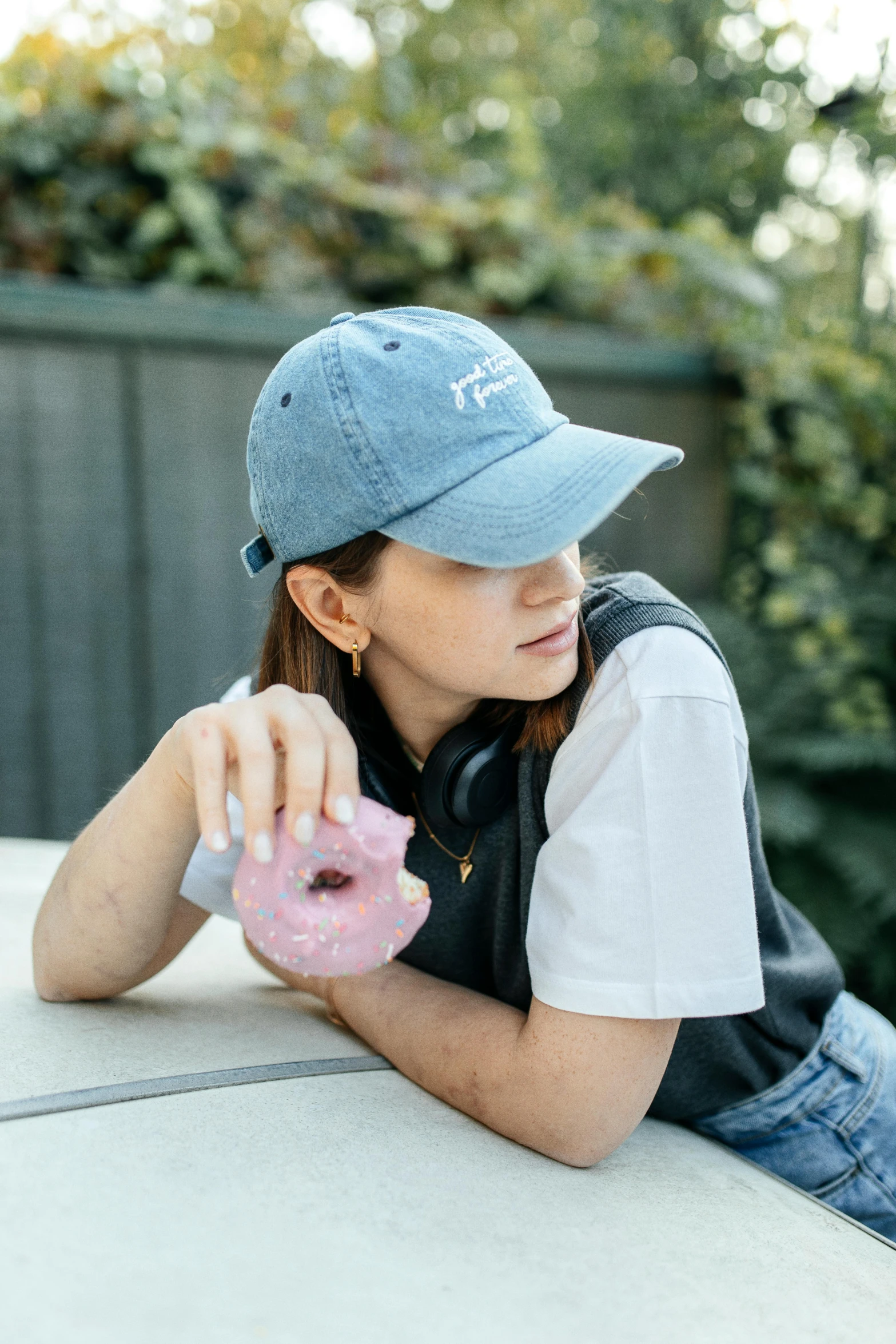  sitting on a wall with a pink donut