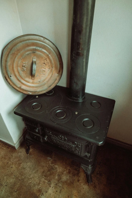 there is an old stove and a small pot on it