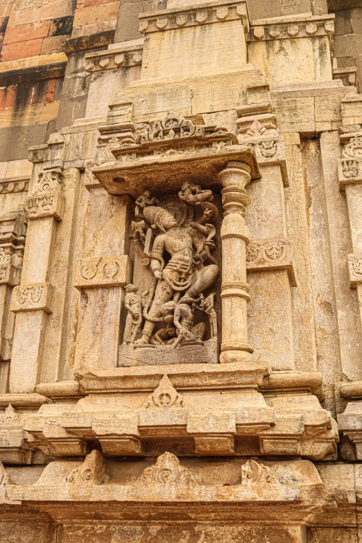 an ornately carved stone architectural structure with sculptures