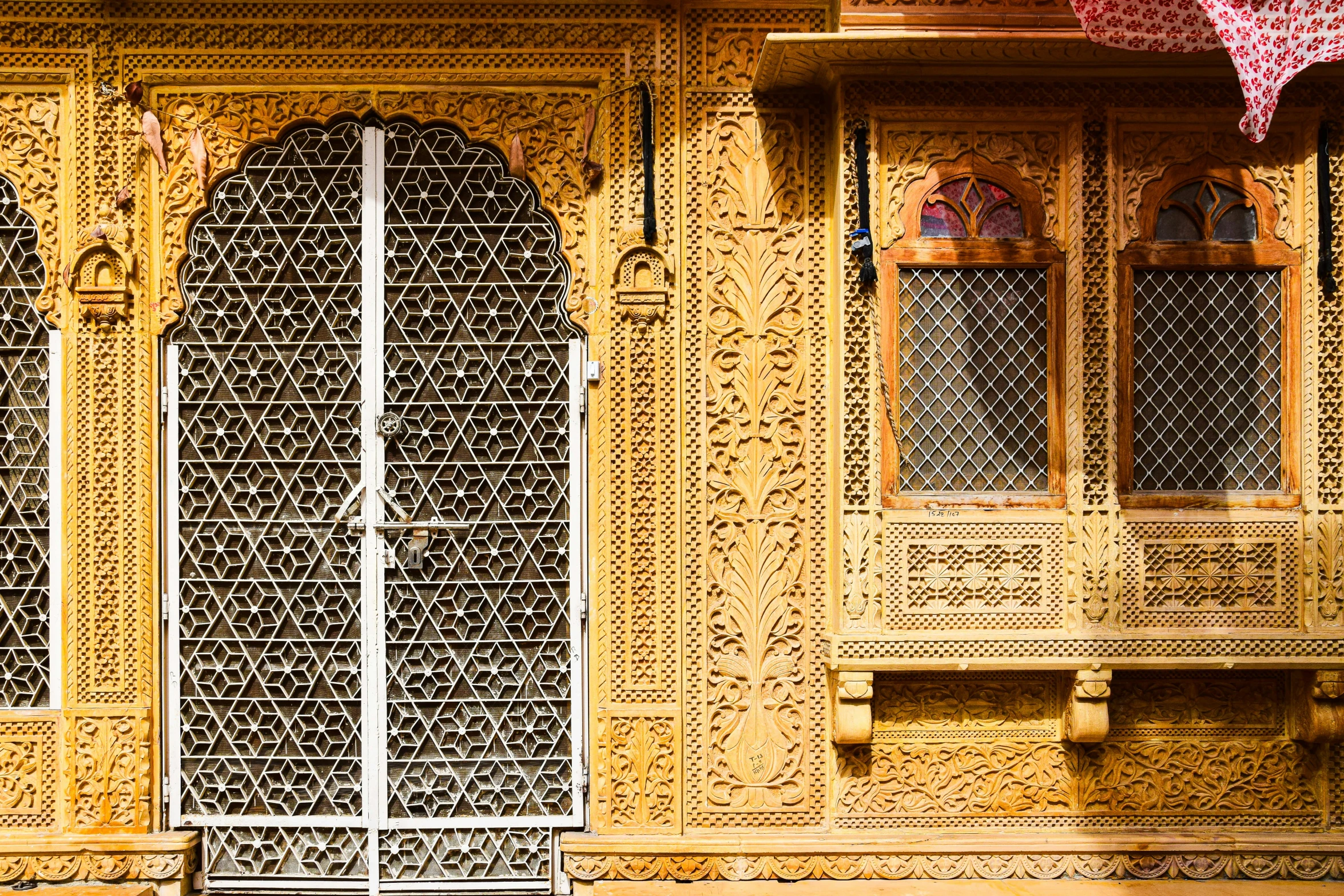 the ornate windows and doors are covered with fabric