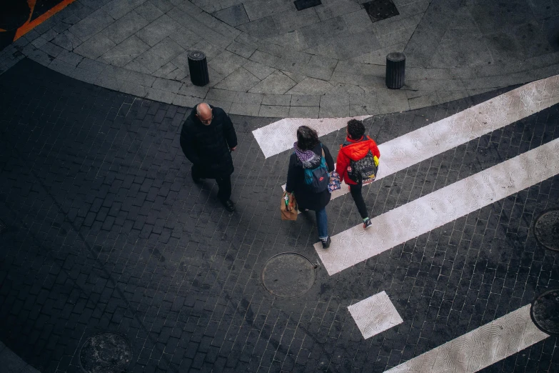 people walk down the street in an intersection