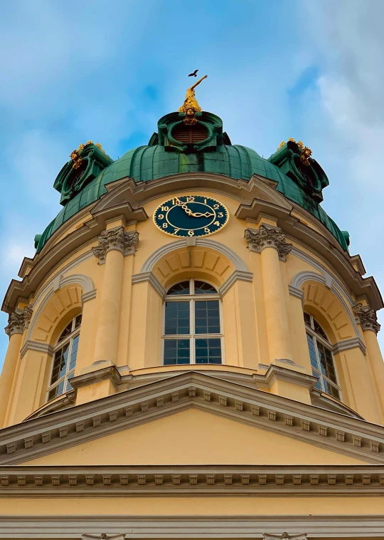 a tower is shown with green and gold decorations