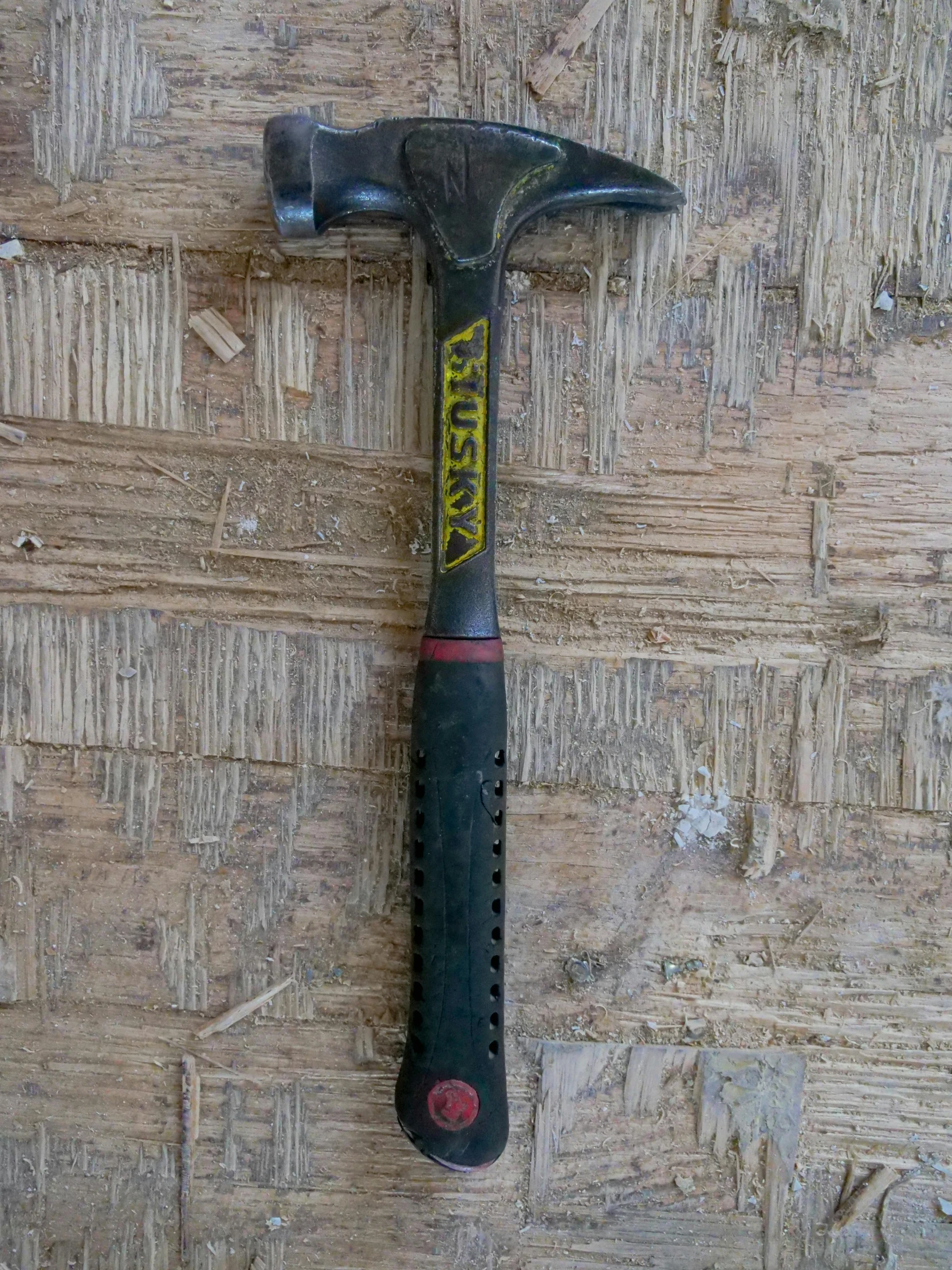 the large hammer is sitting on a piece of wood