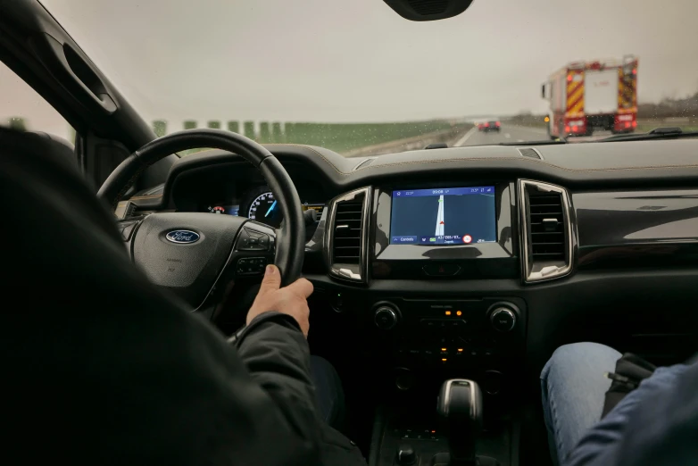 person holding a video game console while driving in a car