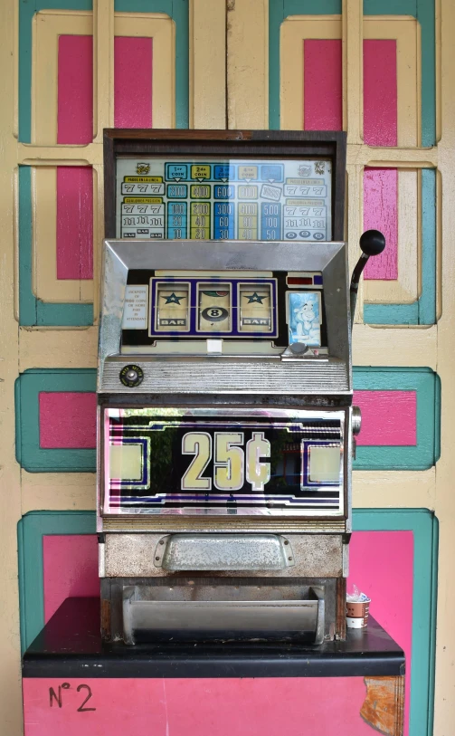 an old fashioned silver cash register machine next to a wall