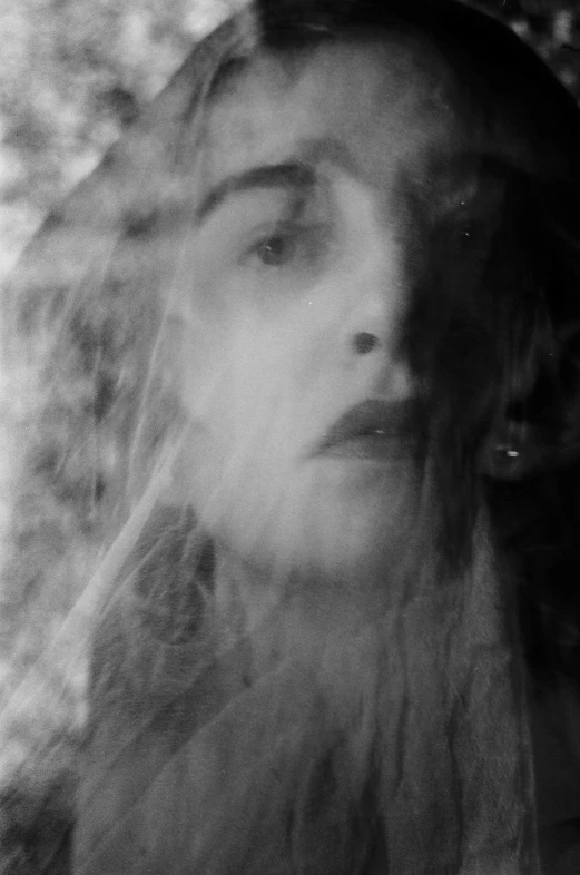 black and white pograph of a woman's face blowing in the wind