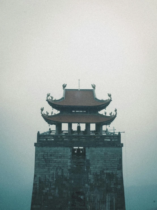a tall tower with a chinese style roof