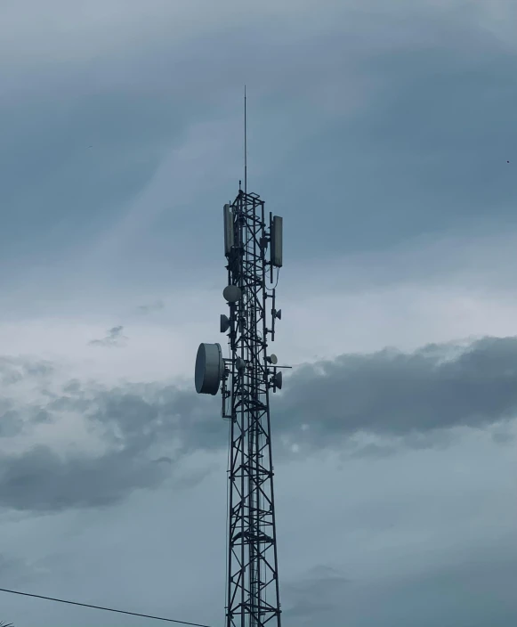 a tall tower with a couple of cell phones on top