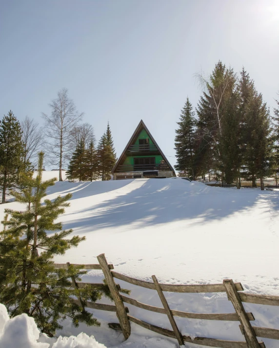 a snowy landscape with a house in the background