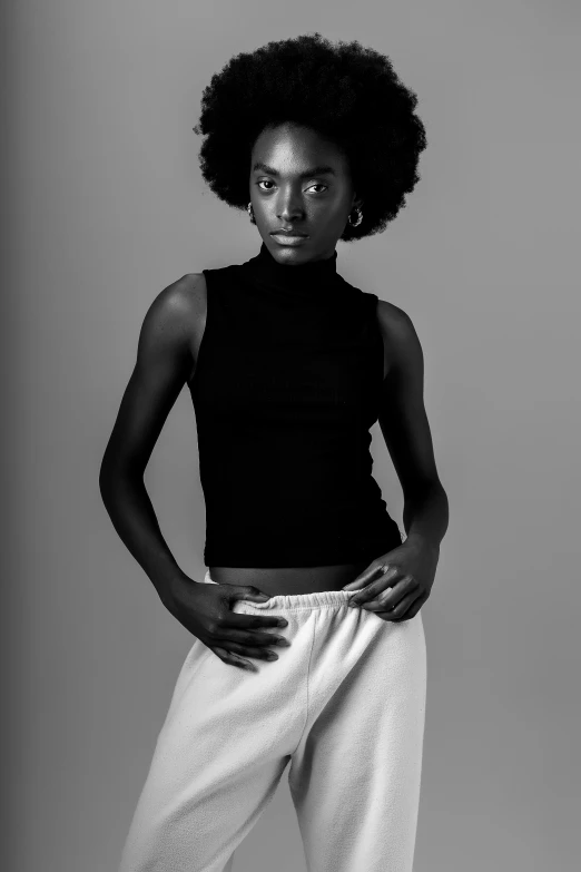 a woman with an afro wears a crop top