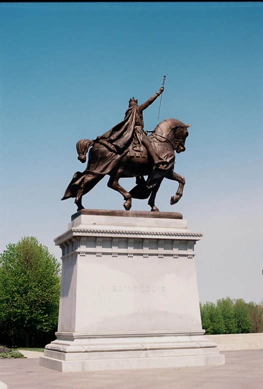 a statue of a man on a horse in a park