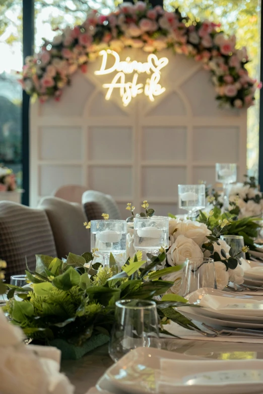 a table with white plates and candles set for a formal dinner