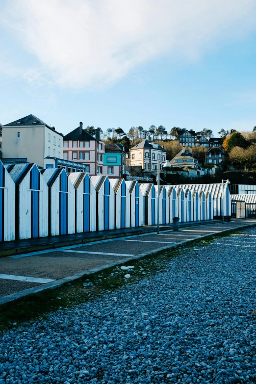 a row of beach huts next to some houses