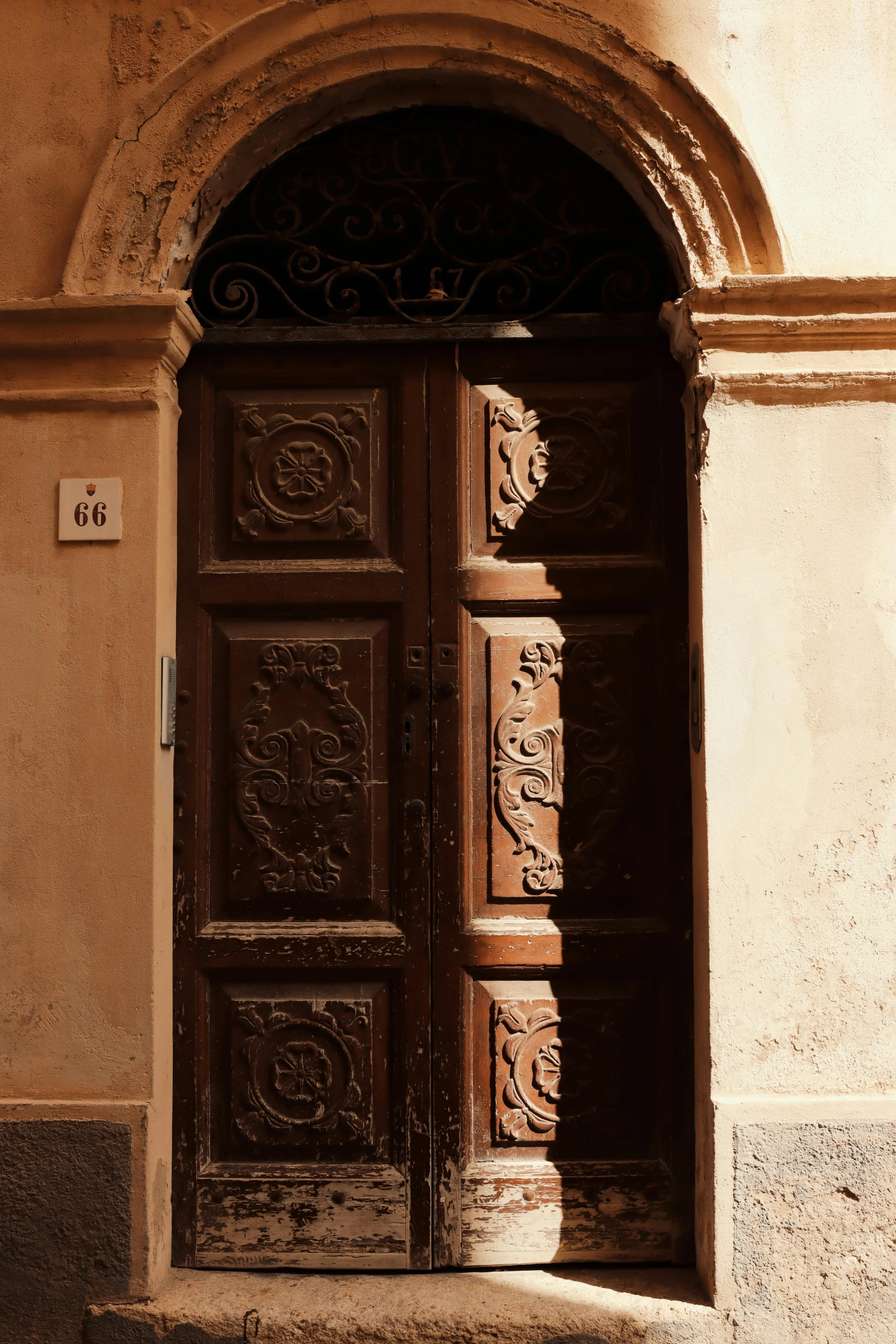 an old door is shown in a stucco building