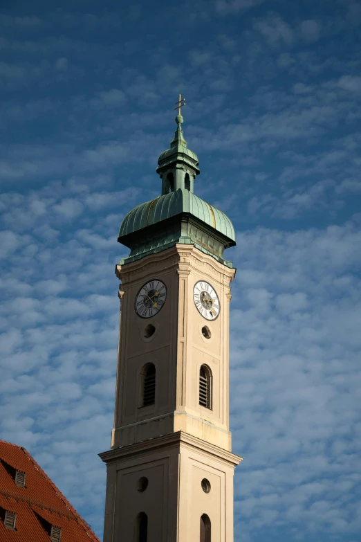 a tall white clock tower towering over a city