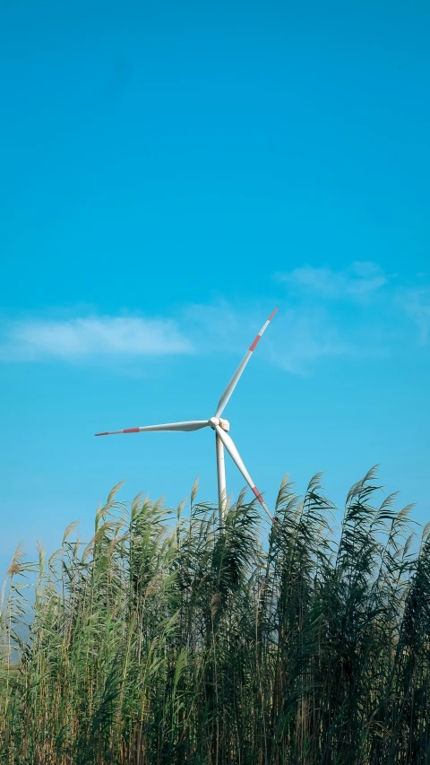 the wind turbine is flying high on the clear blue sky