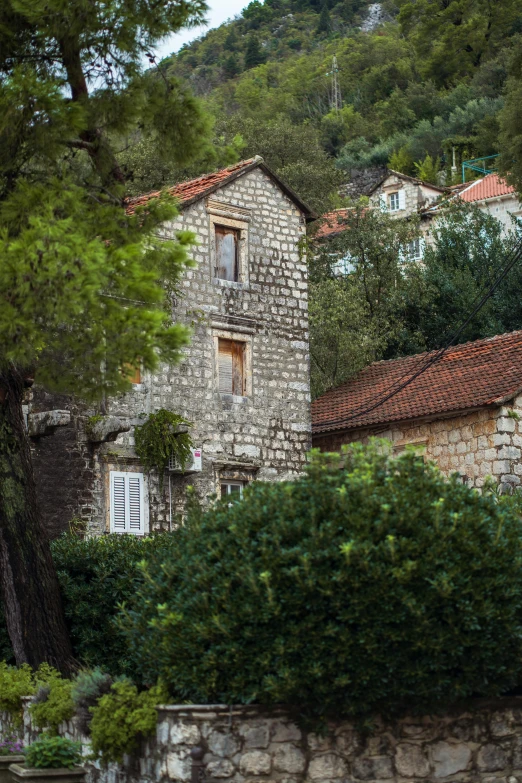 a stone wall with a window on the top and two chimneys