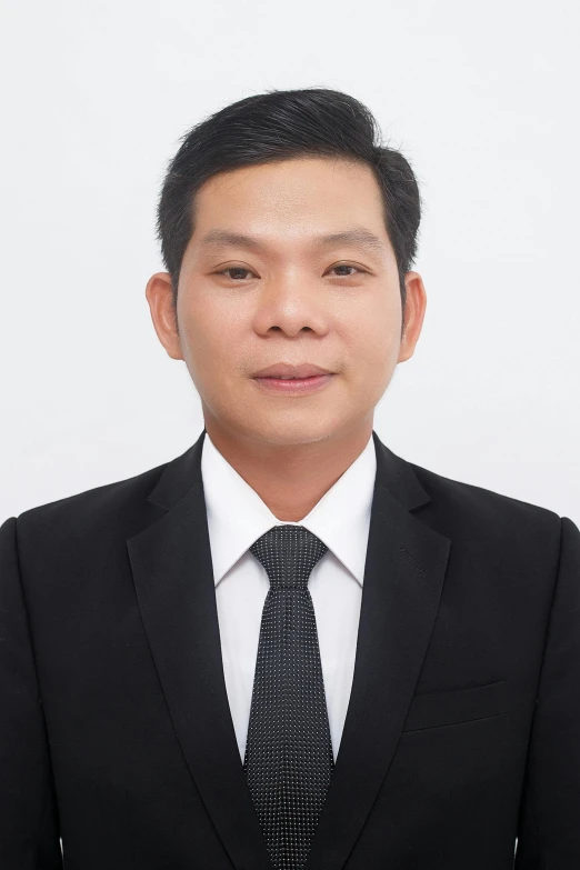 an asian man in a black suit and tie