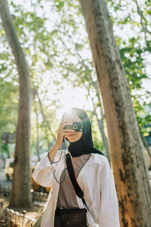 woman wearing glasses with backpack on cell phone