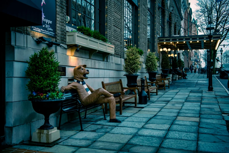 a statue of a person sitting on a bench