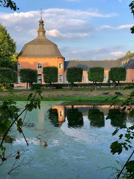 a building by the water is next to another building