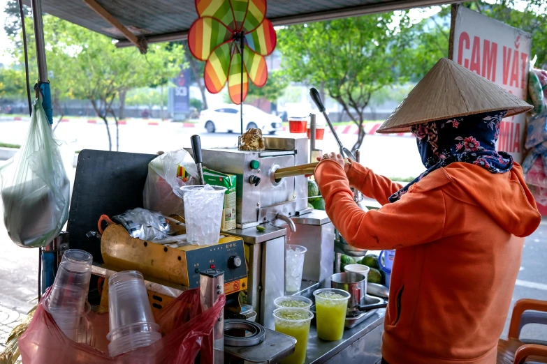 a woman working on an outdoor coffee machine