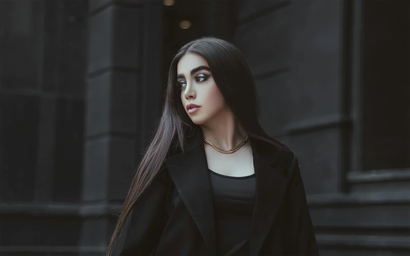 a close up of a person wearing a black coat