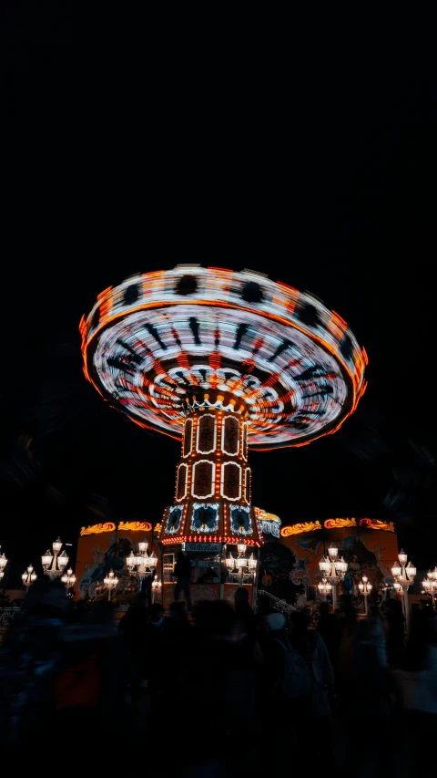 a carnival ride at night with people riding it
