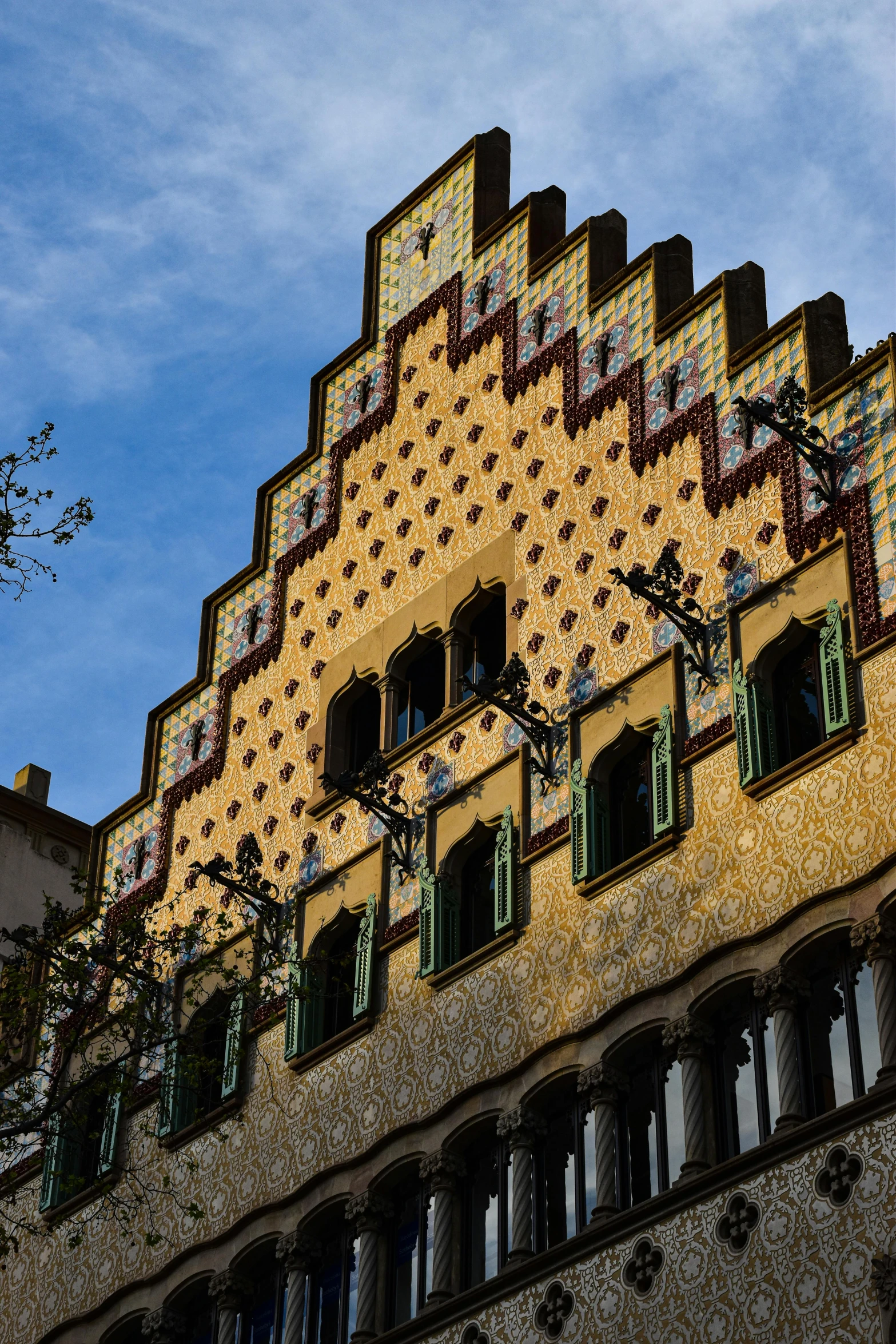 a tall yellow building with lots of windows