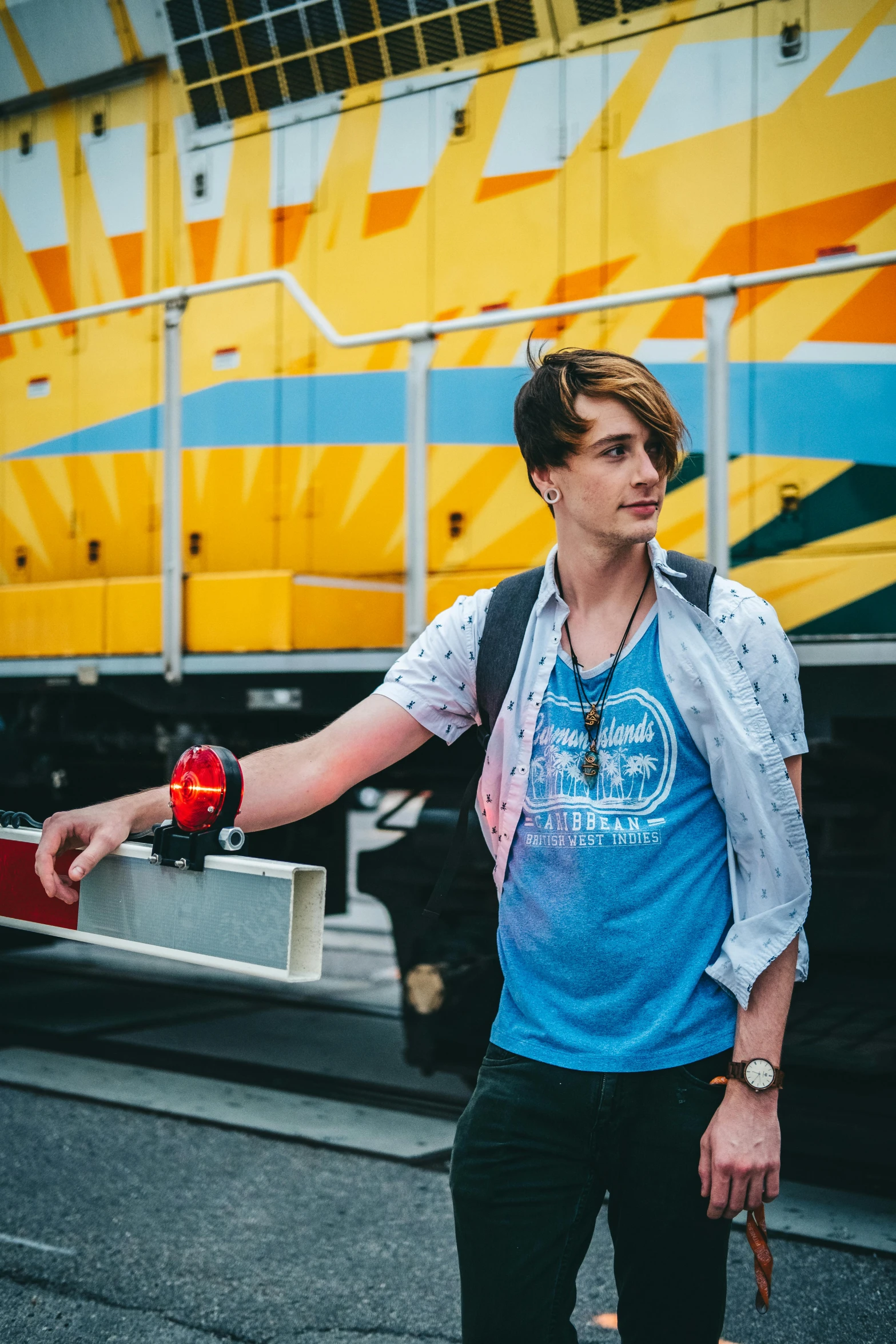 a young man carrying an apple walks down the street