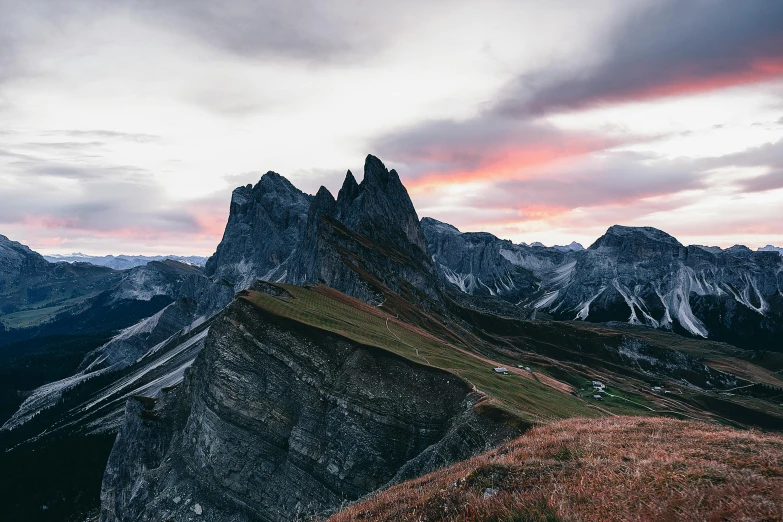 the top of a mountain surrounded by a field