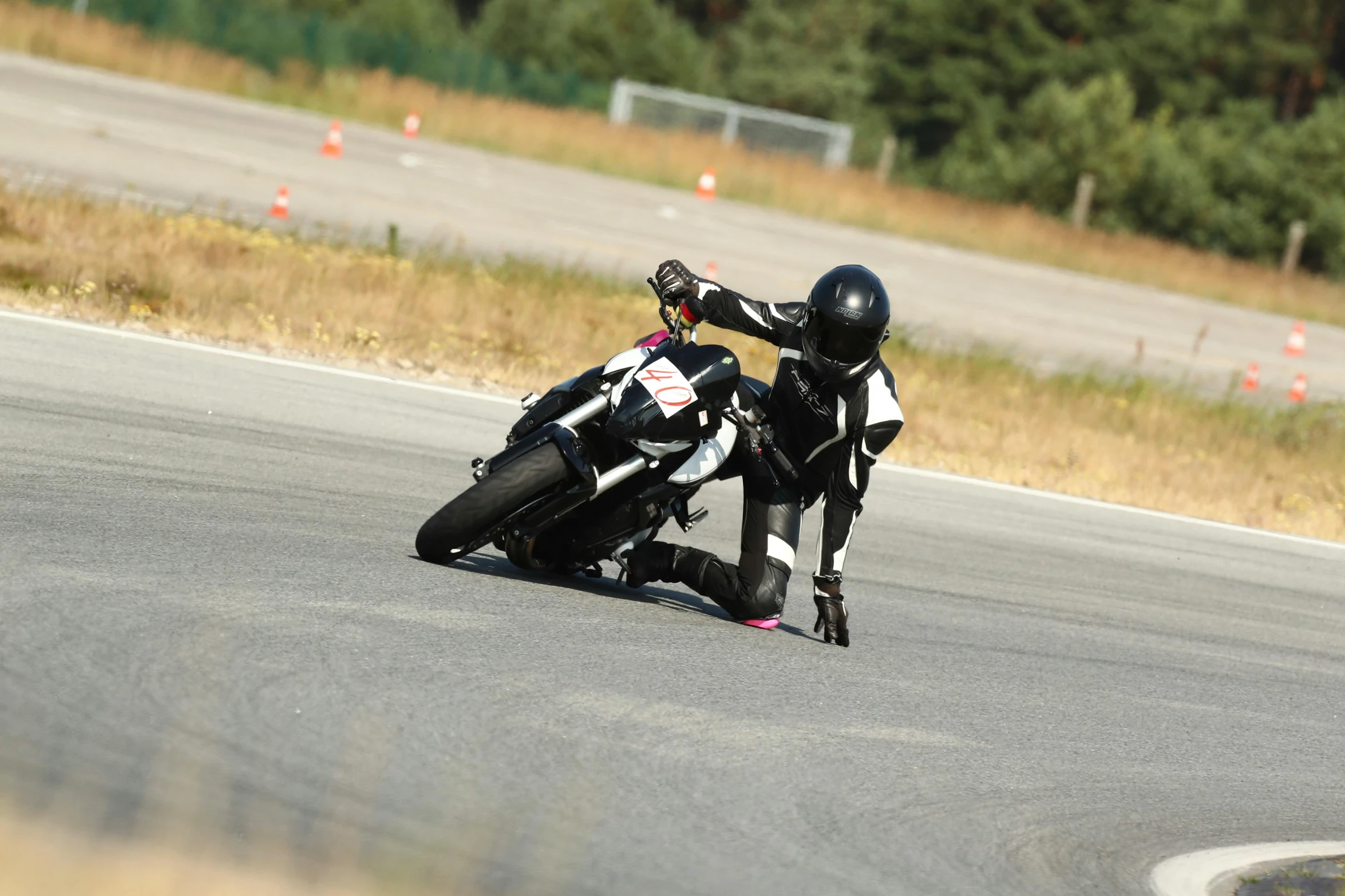 a person on a motorcycle riding around an empty street