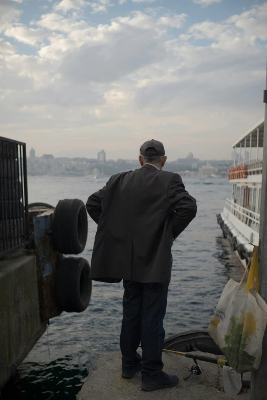 a man that is looking out at the water