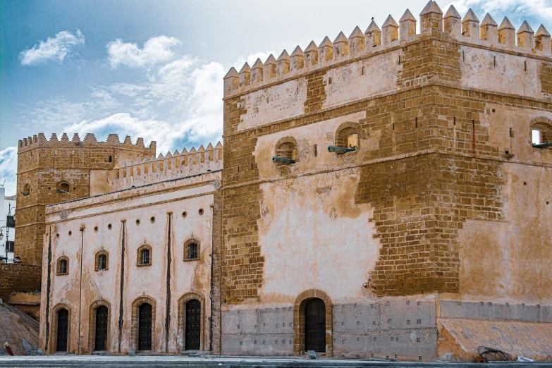 an old castle is shown against the blue sky