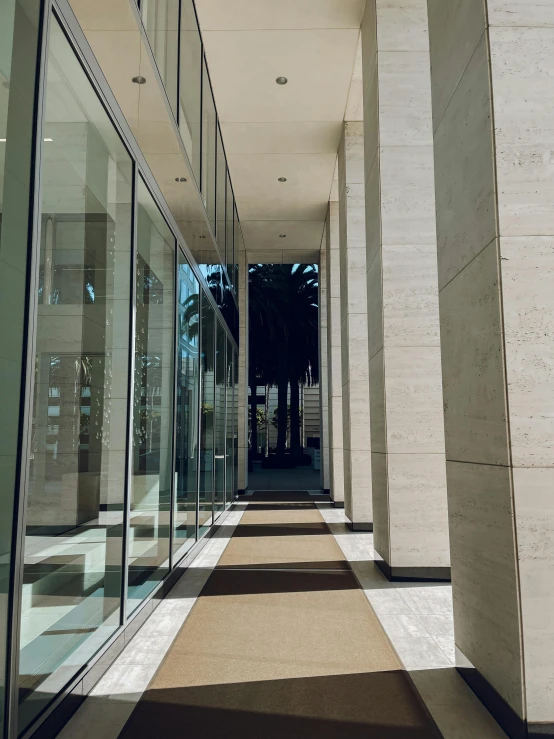 an outdoor walkway with several glass and stone pillars