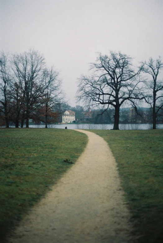 a walk way leading to a house in the distance