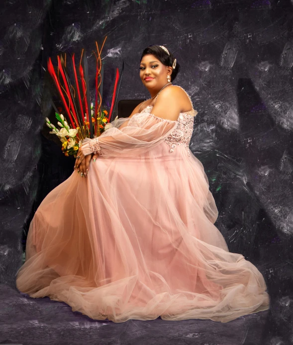 a woman poses with flowers in her hand while holding a large vase