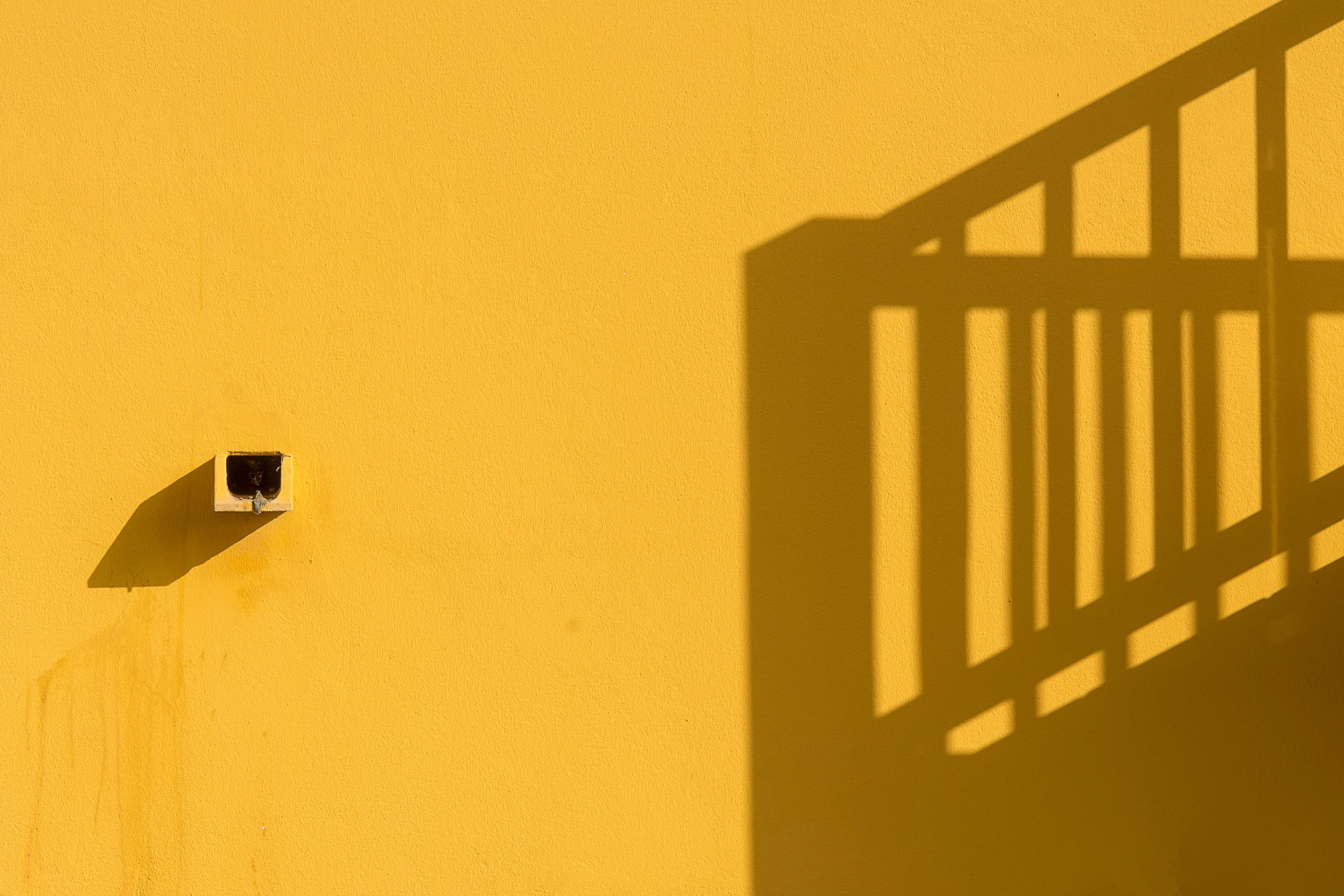 an overhead view of an apartment block and shadow