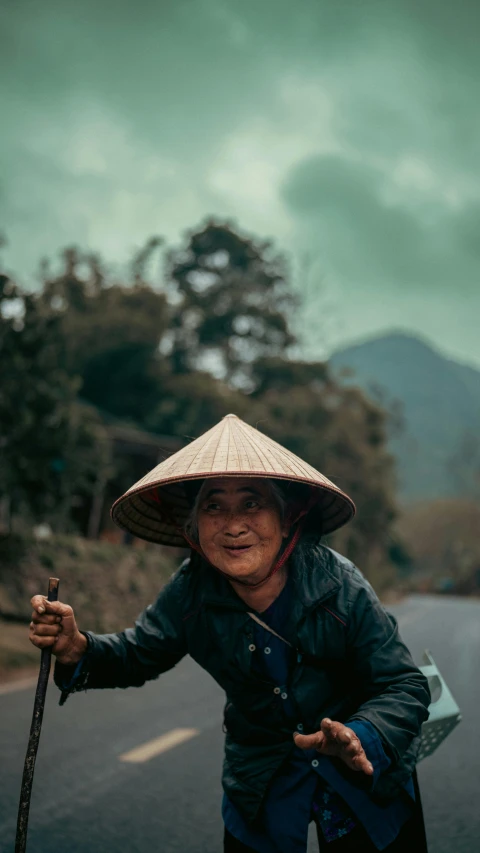 an old woman carrying a stick on her shoulder