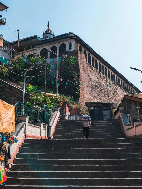 a man walks up stairs by a building