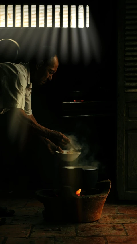 a man cooking food on top of a wok