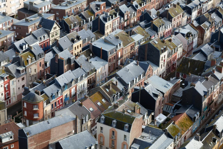 lots of roofs with blue and red brick buildings in the city