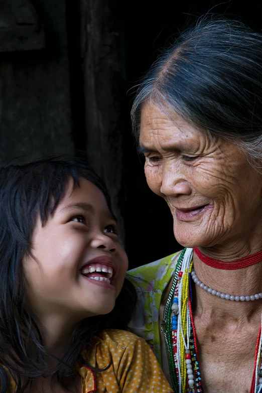 an older asian woman and  with beads