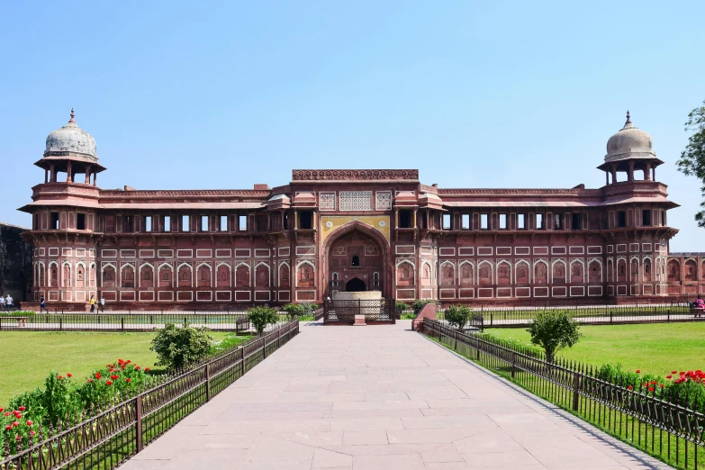 an old building with ornate architecture next to flowers