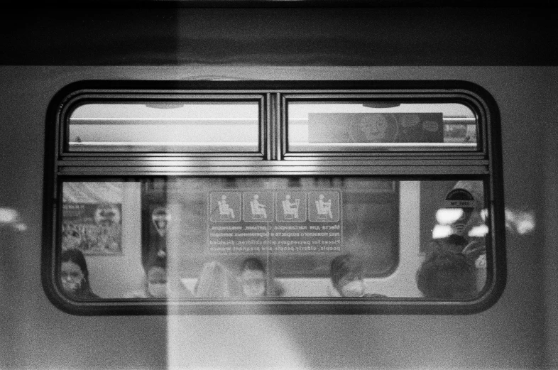 window in train with light on, a reflection is seen