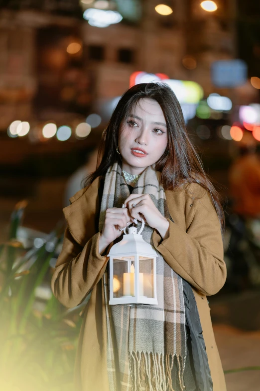 a girl is standing outside with a lantern