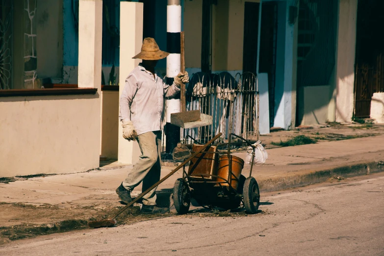 the old man is hing a wheelbarrow outside of the store